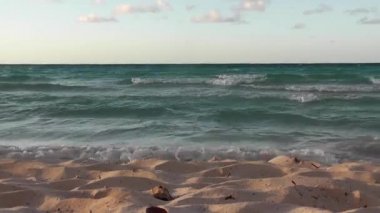 Dalgalar kumsala ulaşırken bir insan önde yürüyor..