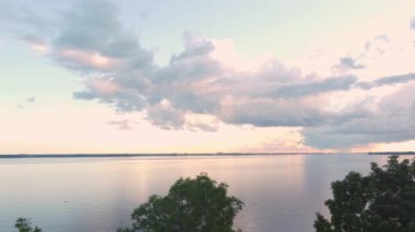 Aerial drone shot near the St-Lawrence River in Quebec at sunset with stormy clouds in sight