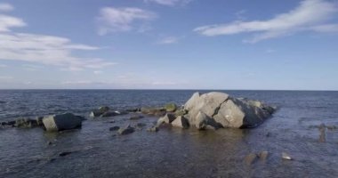 Slow movement over the sea, with a drone, on a clear summer day