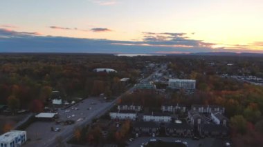 Drone video, rotating slowly, showing a beautiful sunset in Fabreville, Laval, with the Lake of Two Mountains in the background