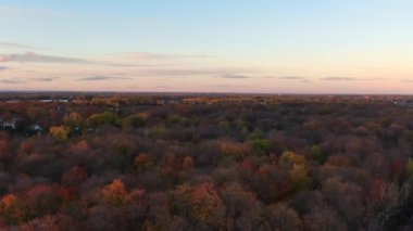 Drone crane video, revealing the Bois de la Source and houses, in Fabreville, in the Fall at sunset
