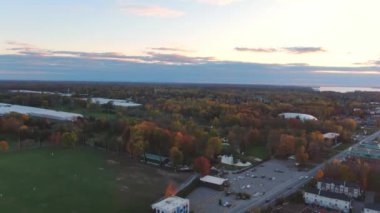 Drone crane view, at sunset, revealing the UFO golf in Fabreville at Fall with colorful trees