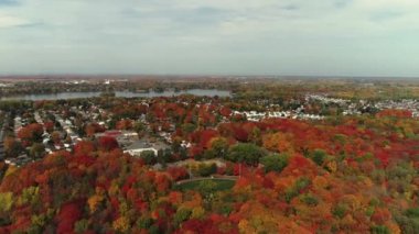 Drone shot revealing the houses in the suburb in Fabreville, rotating slowly from left to right showing the colorful trees in the Fall