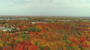 Drone crane shot, coming down showing the houses in the suburb in Fabreville, with the colorful trees in the Fall