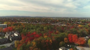 Drone crane shot revealing the houses in the suburb in Fabreville, with the Mille Iles river in the background in the Fall