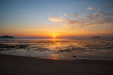 Scene of sunrise and beautiful sky over the sea at Saphanhin public park,Phuket.