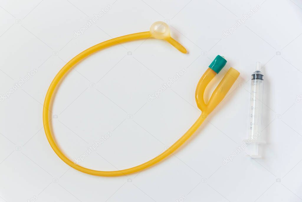 Urinary foley catheter with inflated balloon and syringe on white background.