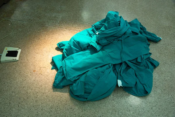 Surgical gowns after surgery on the floor in operating room