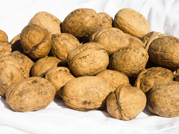 Walnuts on white fabric — Stock Photo, Image