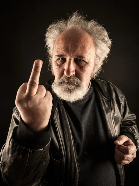 Grumpy man showing middle finger — Stock Photo, Image