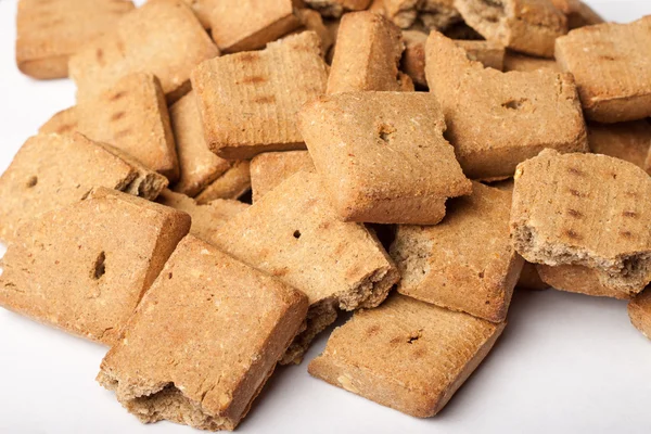 Pile of broken dog treats — Stock Photo, Image