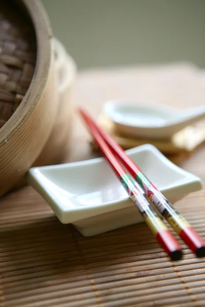 Chinese bamboo steam set with chopsticks and white bowls — стокове фото