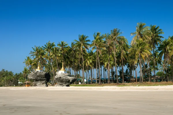 Dos pagodas doradas sentadas sobre rocas encontradas en la playa de Ngwe Saung, costa oeste de Myanmar . —  Fotos de Stock