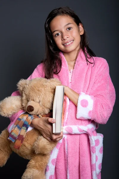 Νεαρό κορίτσι έτοιμοι για ύπνο με το βιβλίο και αρκουδάκι στο βραχίονα — Φωτογραφία Αρχείου