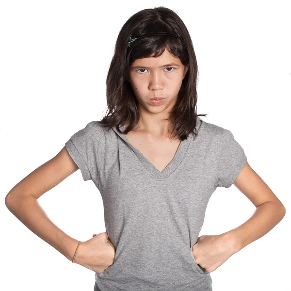 Young angry girl standing with hands on hip — Stock Photo, Image