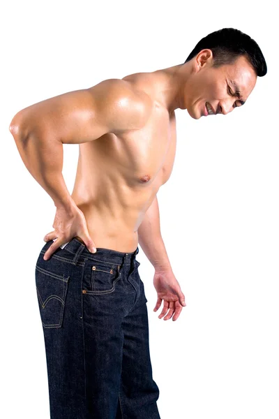 Man grimaces as he suffers from pain on lower back — Stock Photo, Image