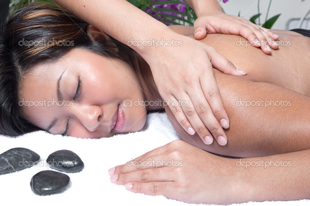 Young Asian woman enjoying a back massage at spa