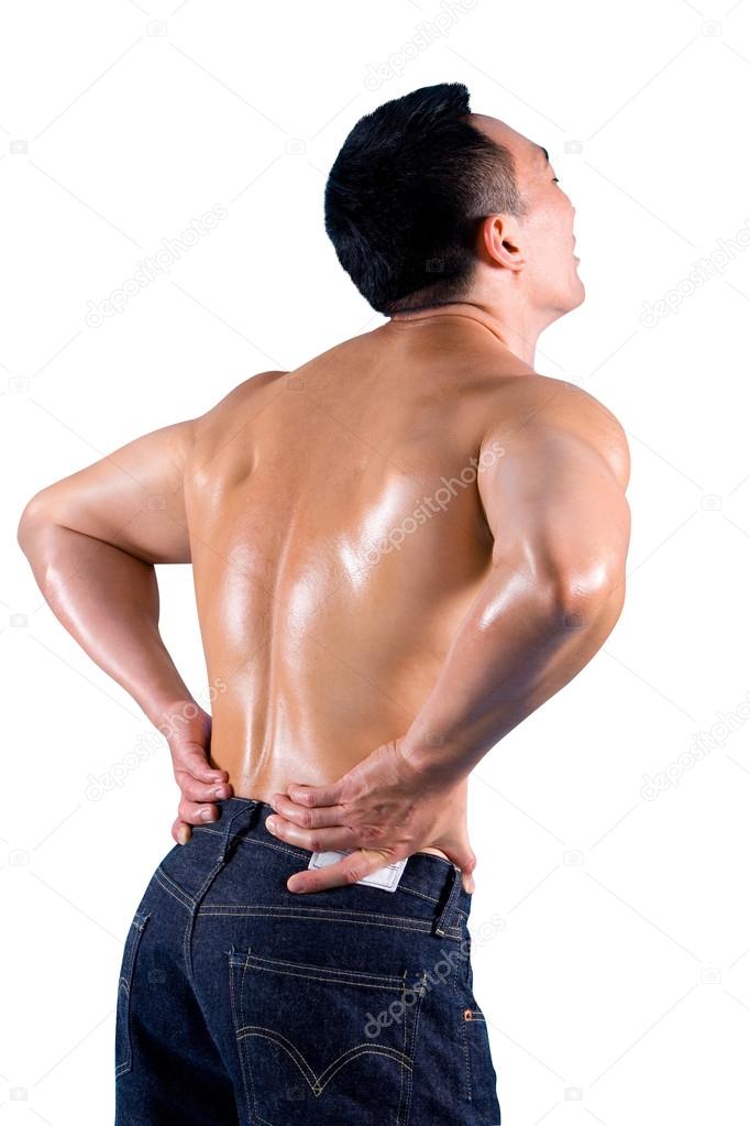 Muscular young man clutching his lower back, suffering from back pain.