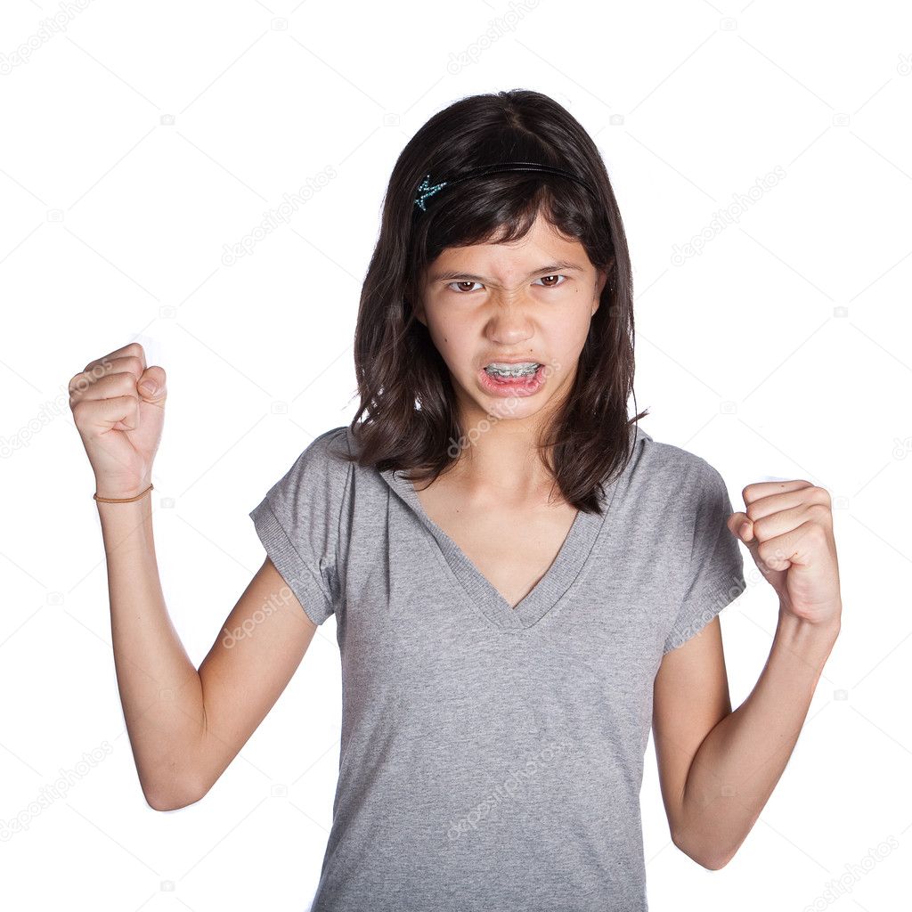 A very angry young girl with fist in air about to hit