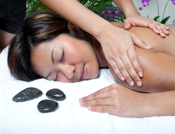 Young Asian woman enjoying a back massage at spa — Stock Photo, Image