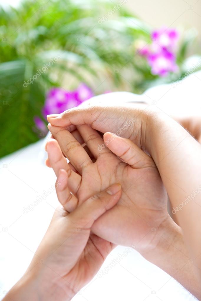 Woman receiving hand massage in spa