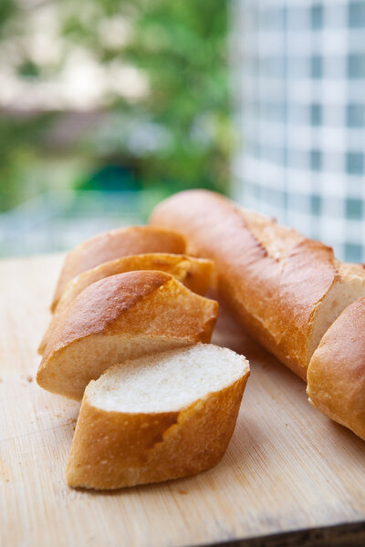 Freshly baked french bagguette on wooden board