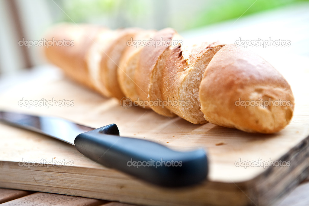 Freshly baked french bagguette on wooden board