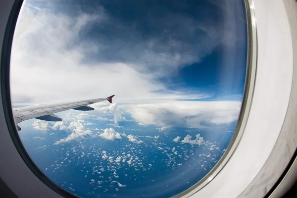 Moln och himmel sett genom ett luftfartygs fönster — Stockfoto