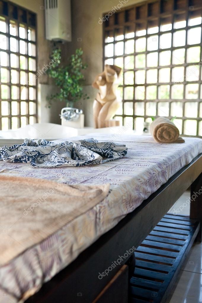Beautiful spa therapy room with wooden windows in Bali