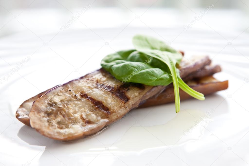 Simple grilled aubergine with olive oil and fresh spinach