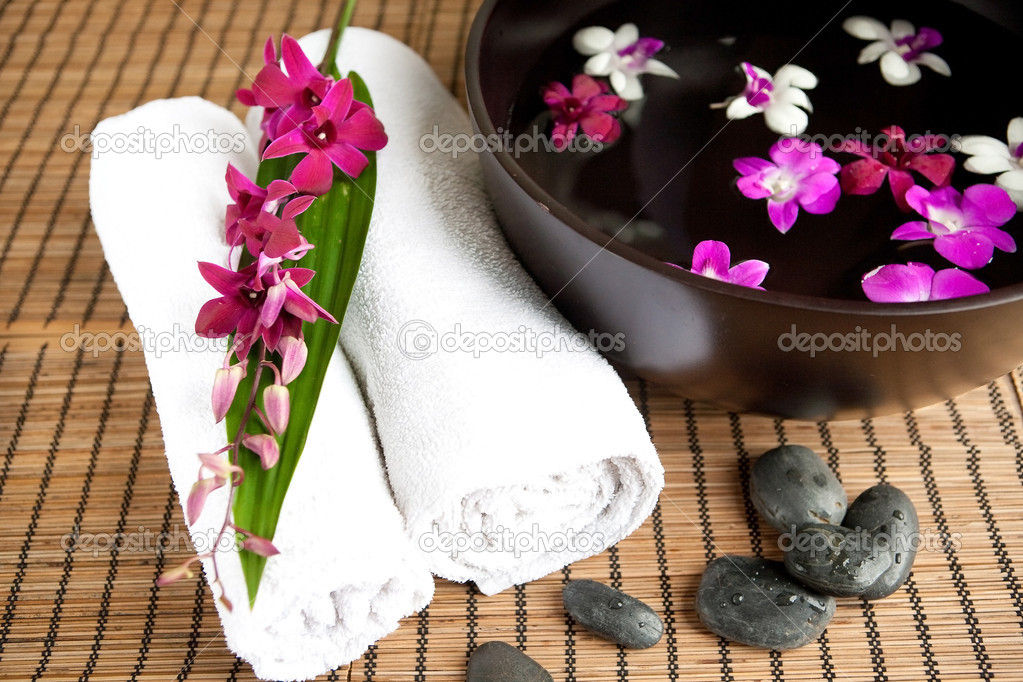 Spa therapy with orchids and hot stones