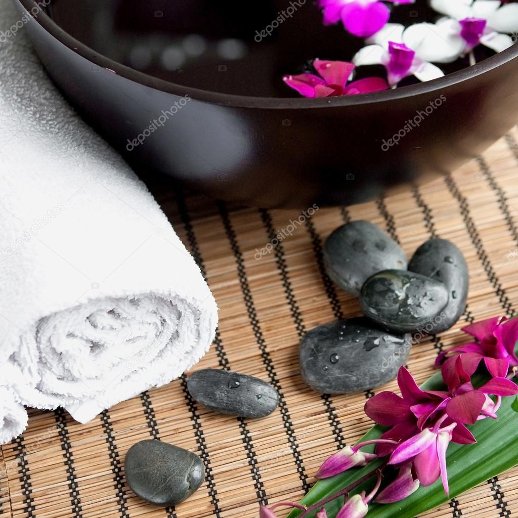 Spa therapy with orchids and hot stones