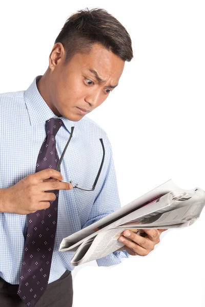 Businessman shocked at the falling stock market on newspaper — Stock Photo, Image