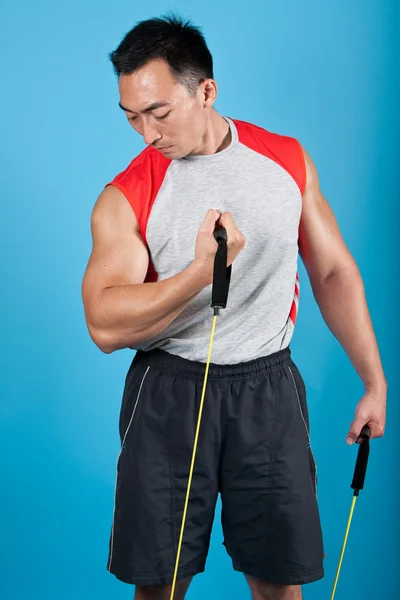Young fit man with exercise stretch band — Stock Photo, Image