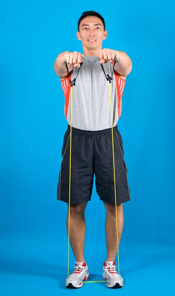 Young fit man with exercise stretch band — Stock Photo, Image