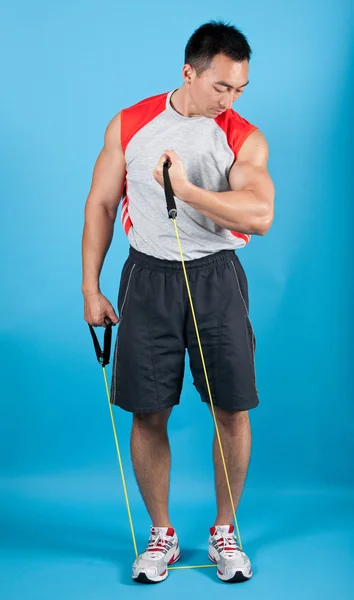 Young fit man with exercise stretch band Royalty Free Stock Images