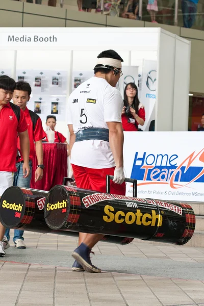 TOA PAYOH, SINGAPORE - MARCH 24 : Contender for Strongman Benjamin Soh attempts the 2 times 120 log walk in the Strongman Challenge 2012 on March 24, in Toa Payoh Hub, Singapore. — Stock Photo, Image