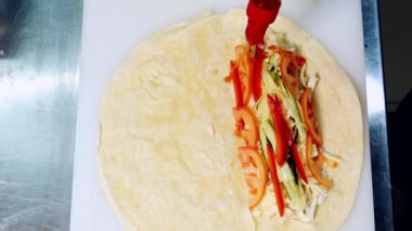 Lezzetli atıştırmalıklar. Pita pişirmek için kırmızı sos dök. Şef et ve sebzeli pidaya ketçap ekler. Üst görünüm.