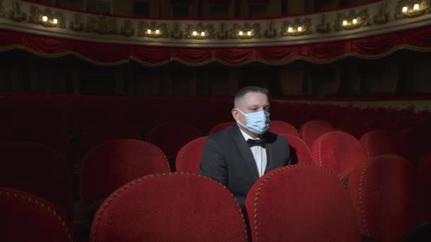 Sad Man Medical Mask Sits Empty Cinema Hall Red Armchairs — 비디오