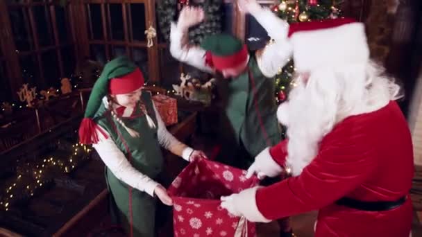 Elves Santa Claus Fill Sack Christmas Presents Elf Putting Gift — Videoclip de stoc