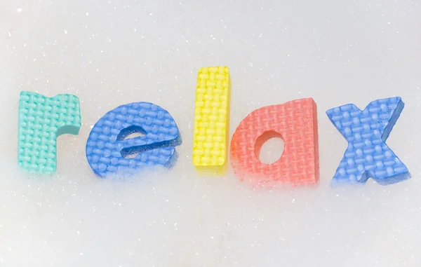 Relax letters in bubble bath foam — Stock Photo, Image