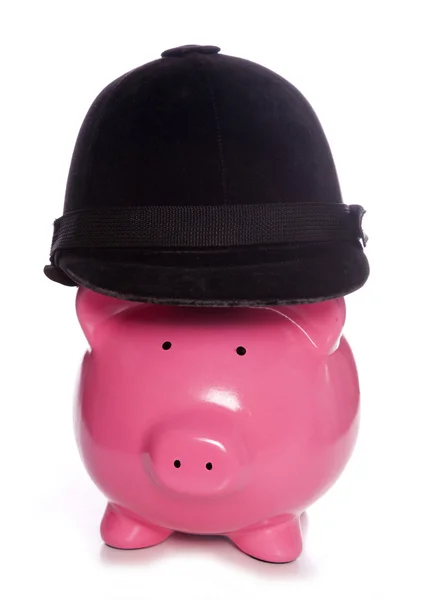 Piggy bank wearing a horse riding hat — Stock Photo, Image