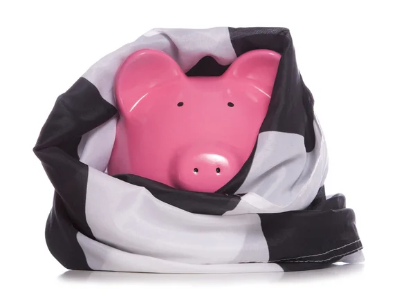 Piggy bank a kockás zászló csomagolva — Stock Fotó