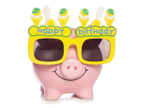 Banco Piggy usando óculos de aniversário — Fotografia de Stock