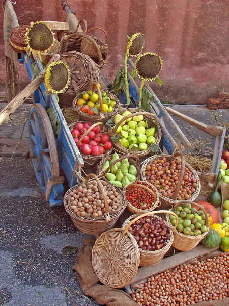 cart full of fresh fruit in a market in autumn