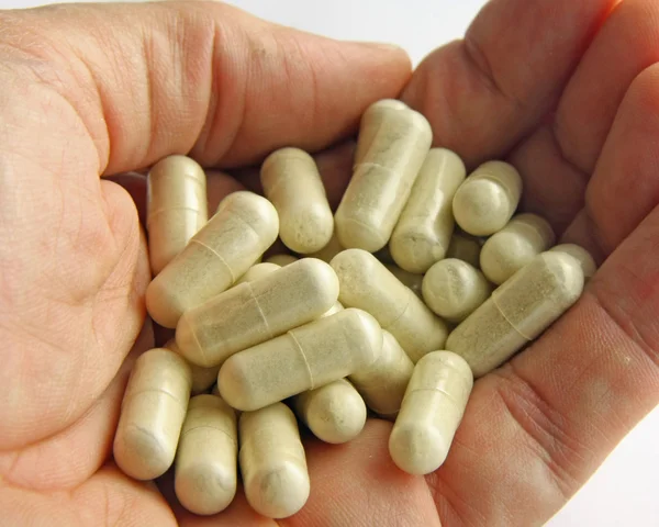 Kézzel, egy ember, aki sok gyógyszer tabletta — Stock Fotó