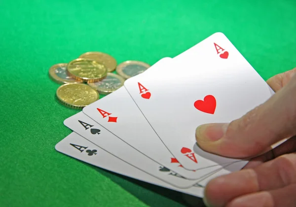Hand with poker of aces on a table game — Stock Photo, Image