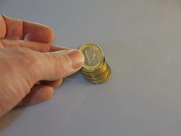 Euro coins ve alır bir el yığını — Stok fotoğraf