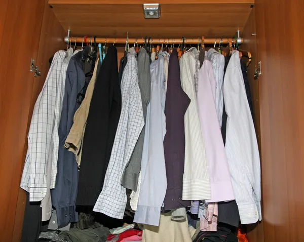 Inside of a closet full of dress shirts and sweaters for men — Stock Photo, Image