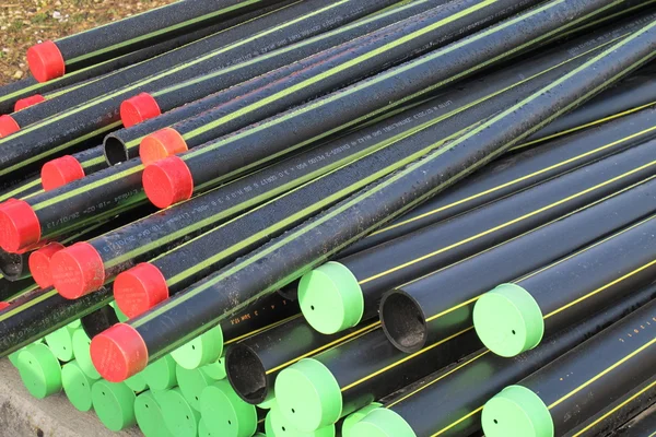 Piles of plastic pipes and conduits for transporting the gas — Stock Photo, Image